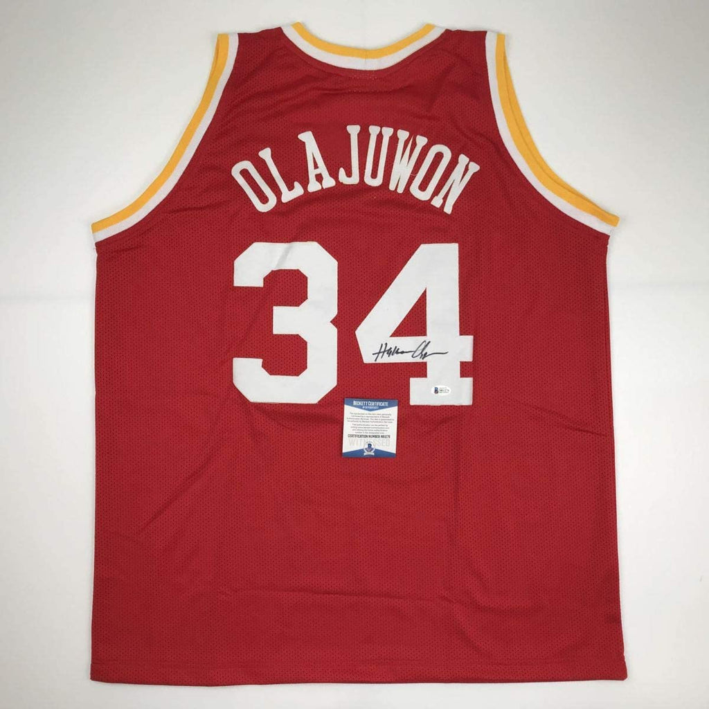 autographed-signed-hakeem-olajuwon-houston-red-basketball-jersey-beckett-bas-coa