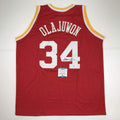 autographed-signed-hakeem-olajuwon-houston-red-basketball-jersey-beckett-bas-coa