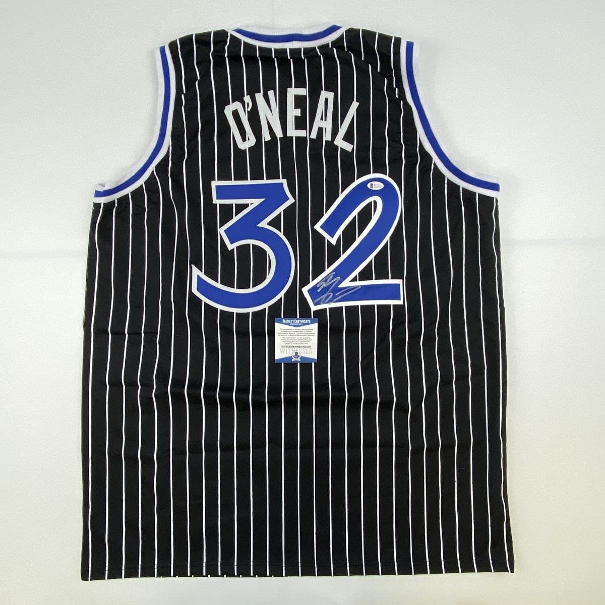 autographed-signed-shaquille-shaq-oneal-orlando-black-pinstripe-basketball-jersey-beckett-bas-coa