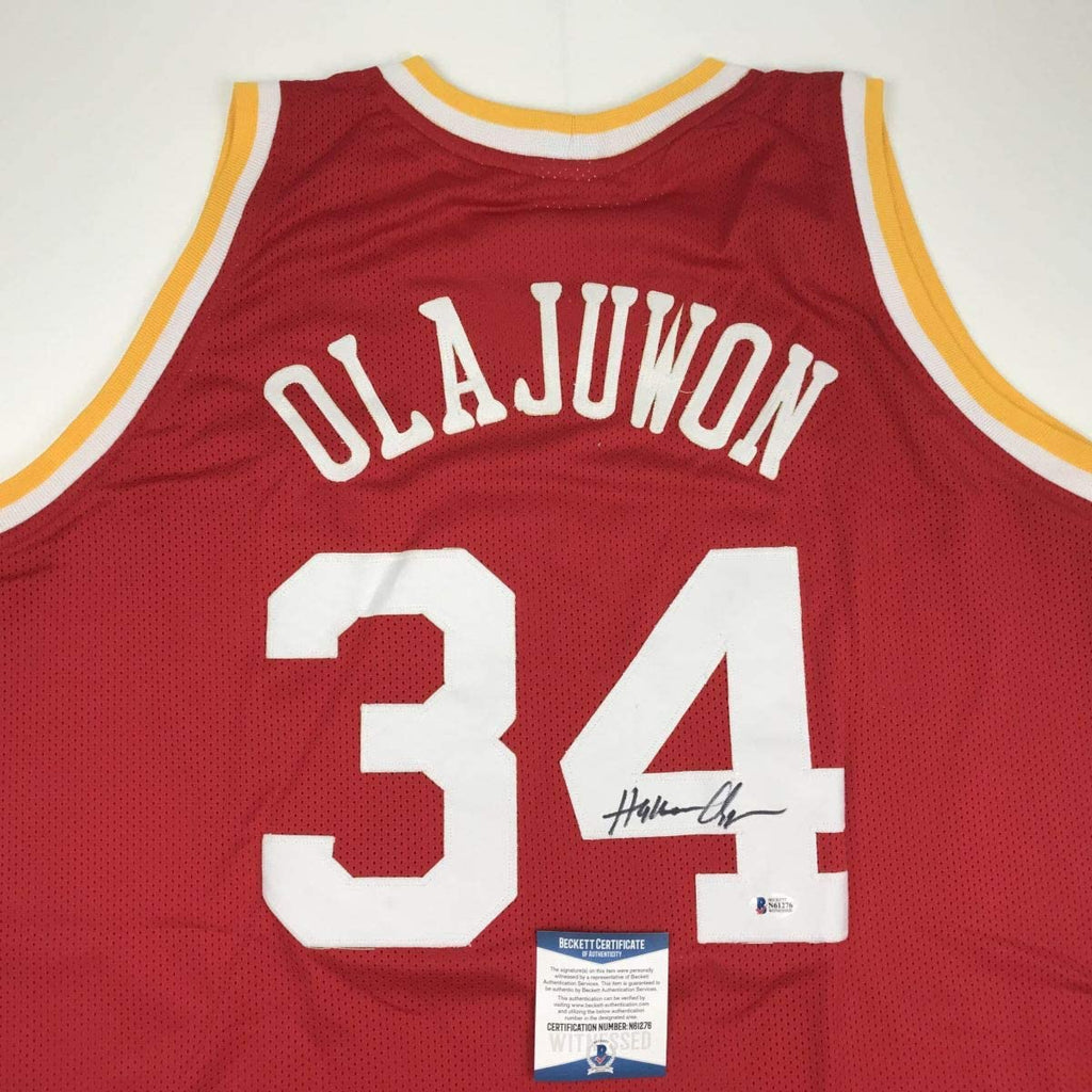 autographed-signed-hakeem-olajuwon-houston-red-basketball-jersey-beckett-bas-coa
