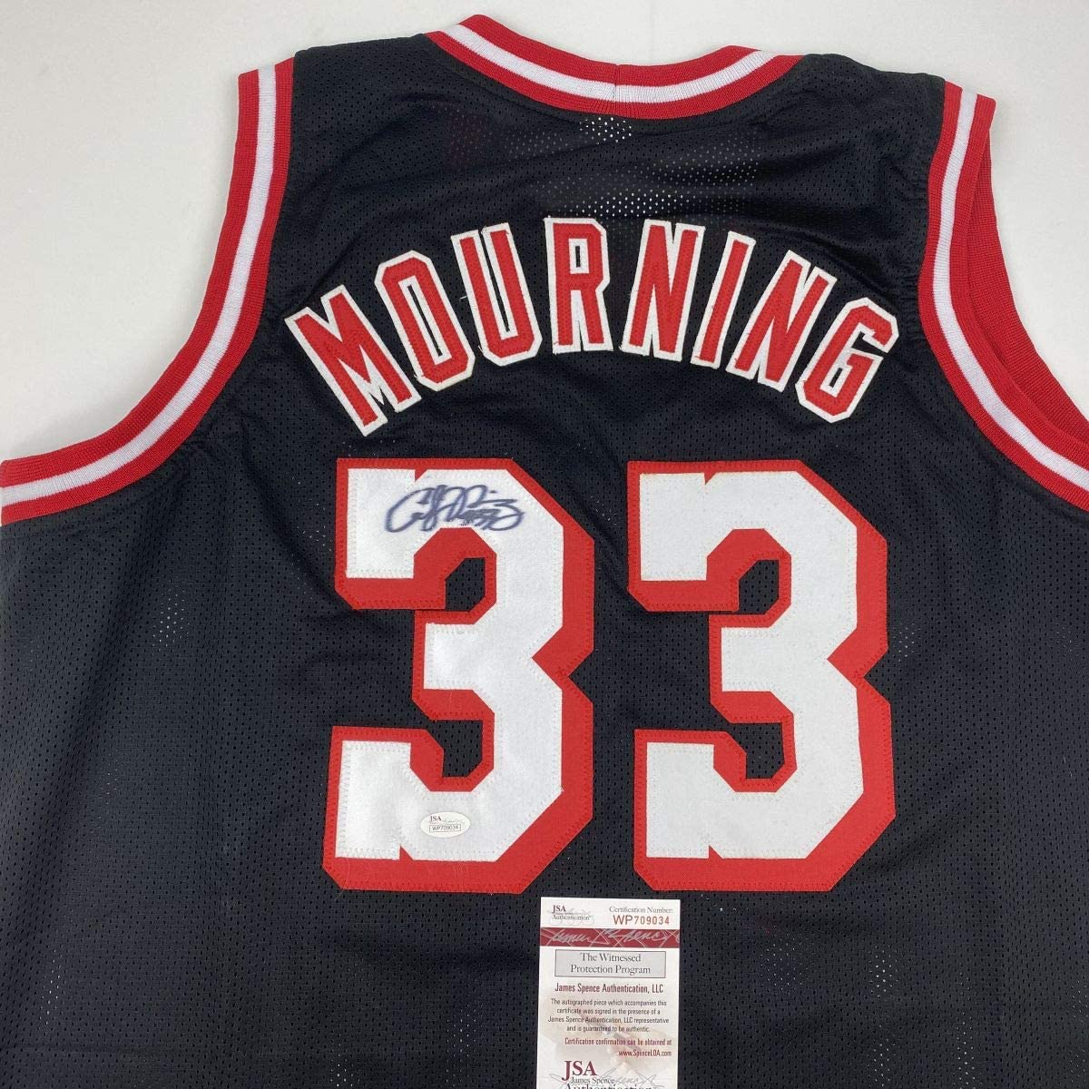 autographed-signed-alonzo-mourning-miami-black-basketball-jersey-jsa-coa