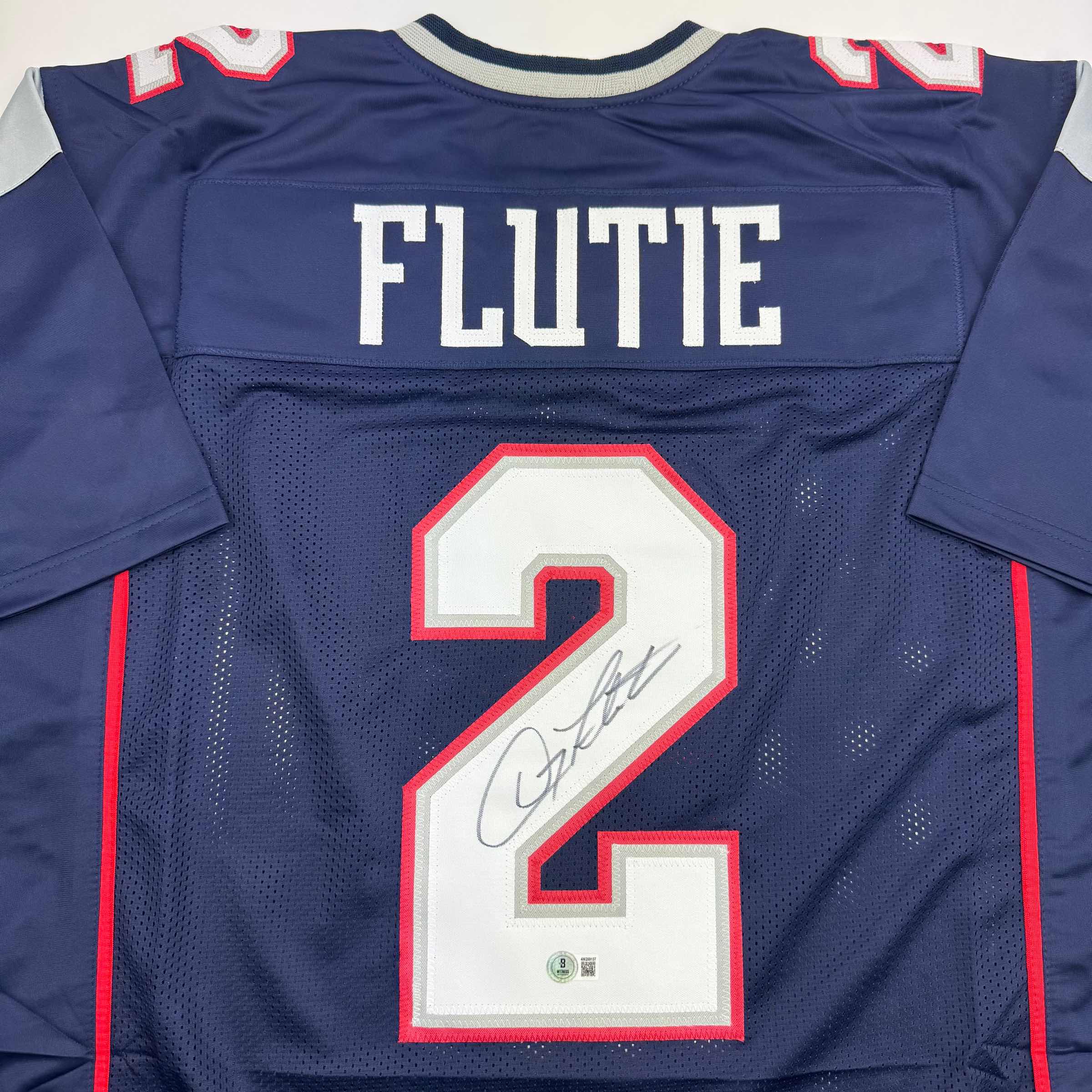 autographed-signed-doug-flutie-new-england-blue-football-jersey-beckett-bas-coa