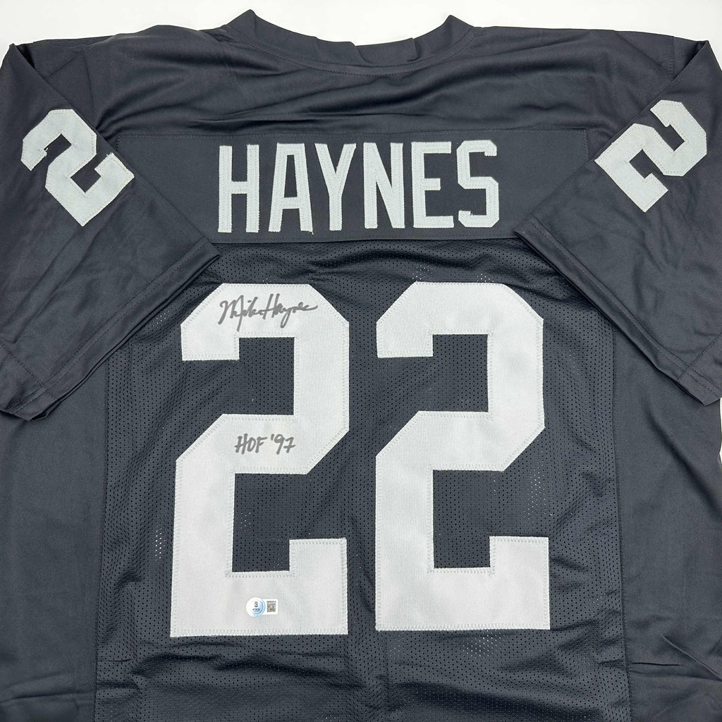 autographed-signed-michael-mike-haynes-hof-97-oakland-black-football-jersey-beckett-bas-coa