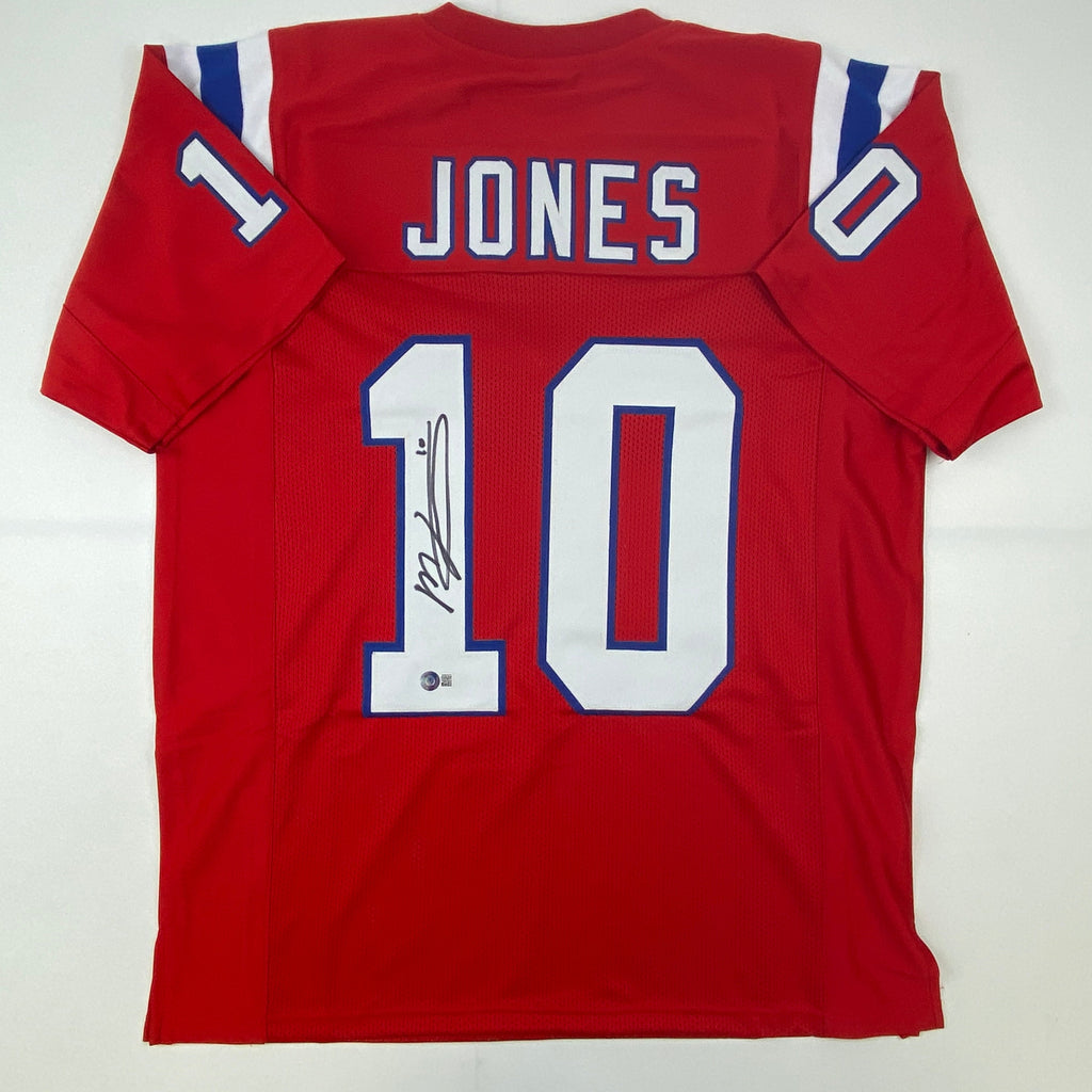 autographed-signed-mac-jones-new-england-red-football-jersey-beckett-bas-coa