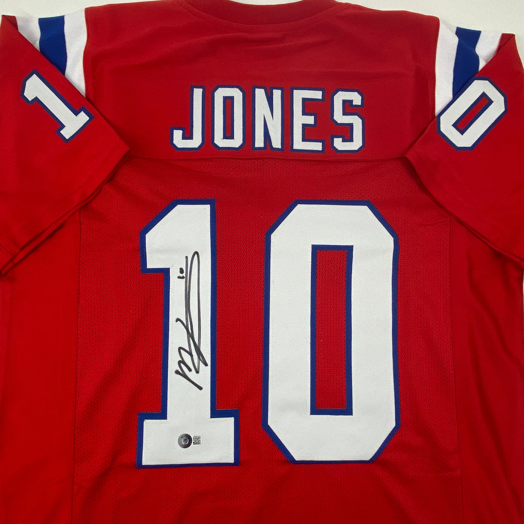 autographed-signed-mac-jones-new-england-red-football-jersey-beckett-bas-coa