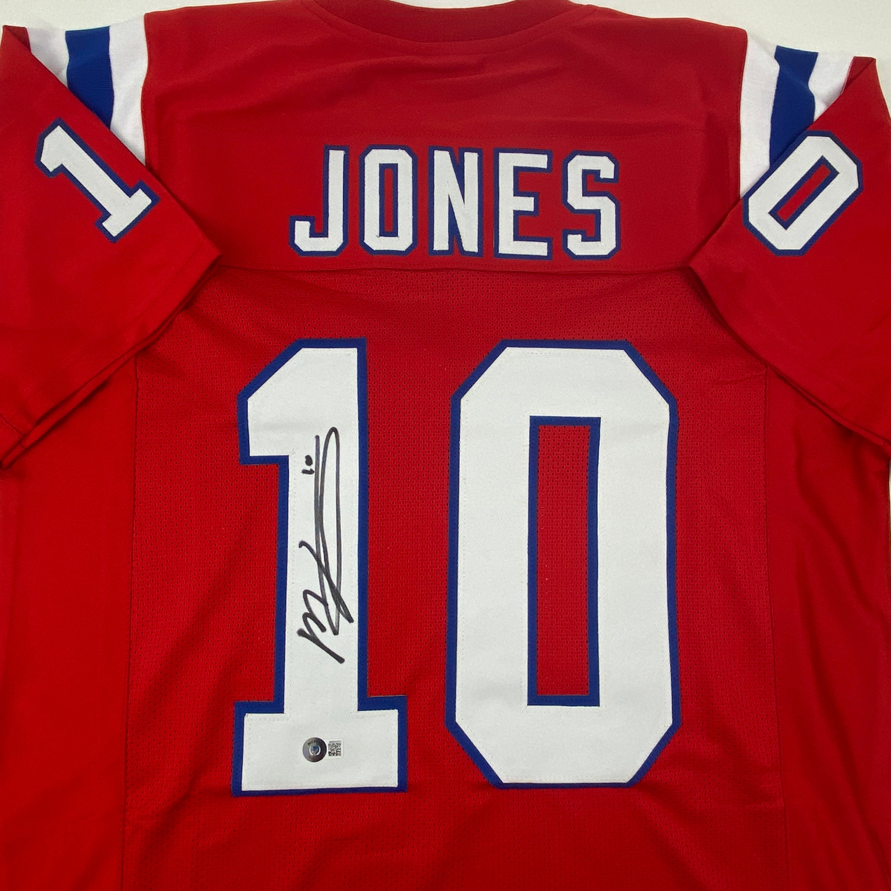 autographed-signed-mac-jones-new-england-red-football-jersey-beckett-bas-coa