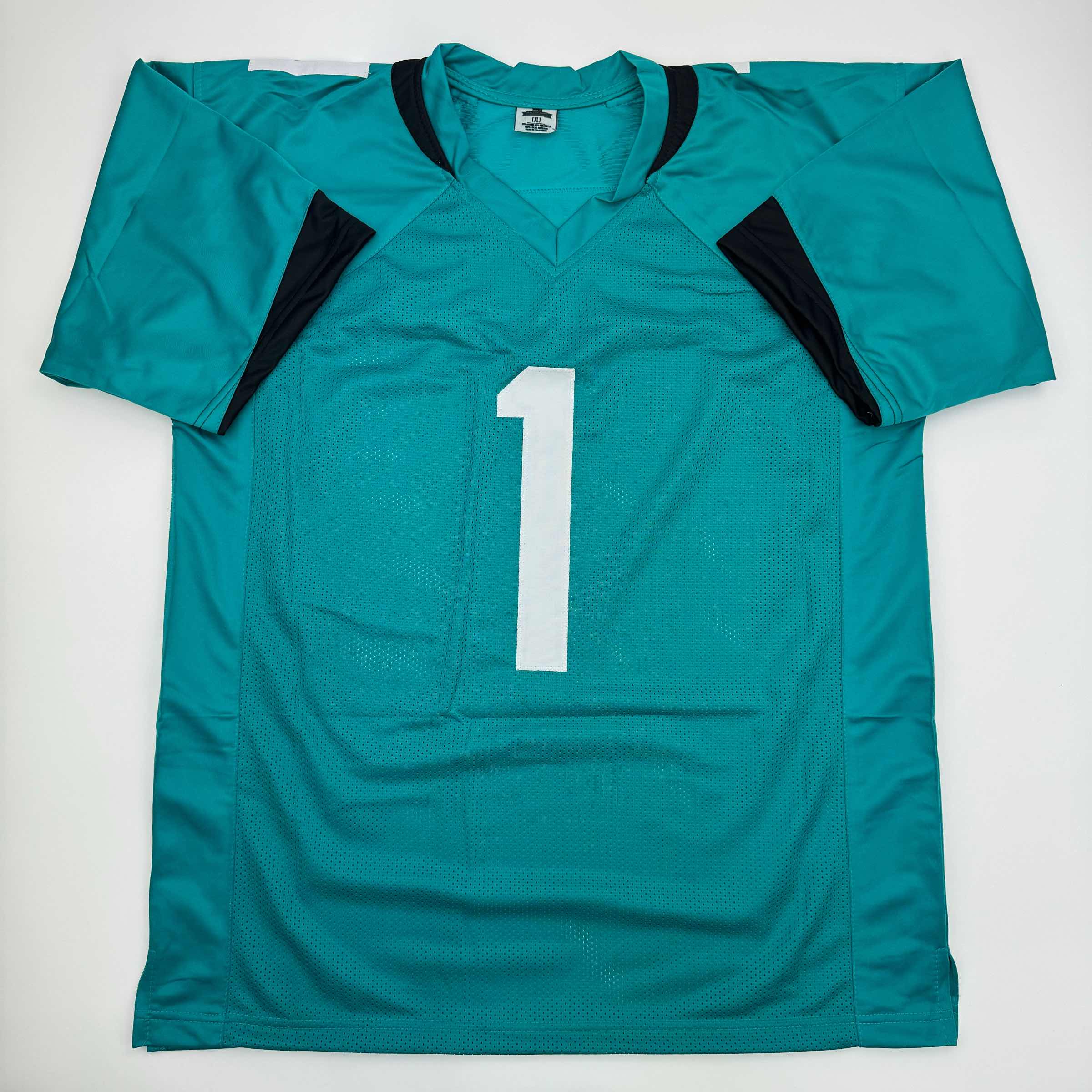 autographed-signed-travis-etienne-jr-jacksonville-teal-football-jersey-beckett-bas-coa