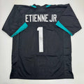 autographed-signed-travis-etienne-jr-jacksonville-black-football-jersey-beckett-bas-coa