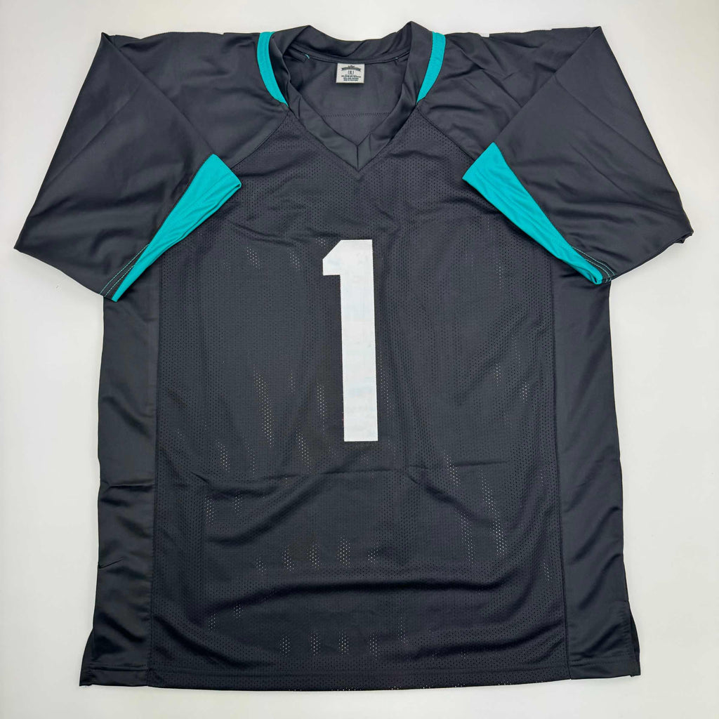 autographed-signed-travis-etienne-jr-jacksonville-black-football-jersey-beckett-bas-coa