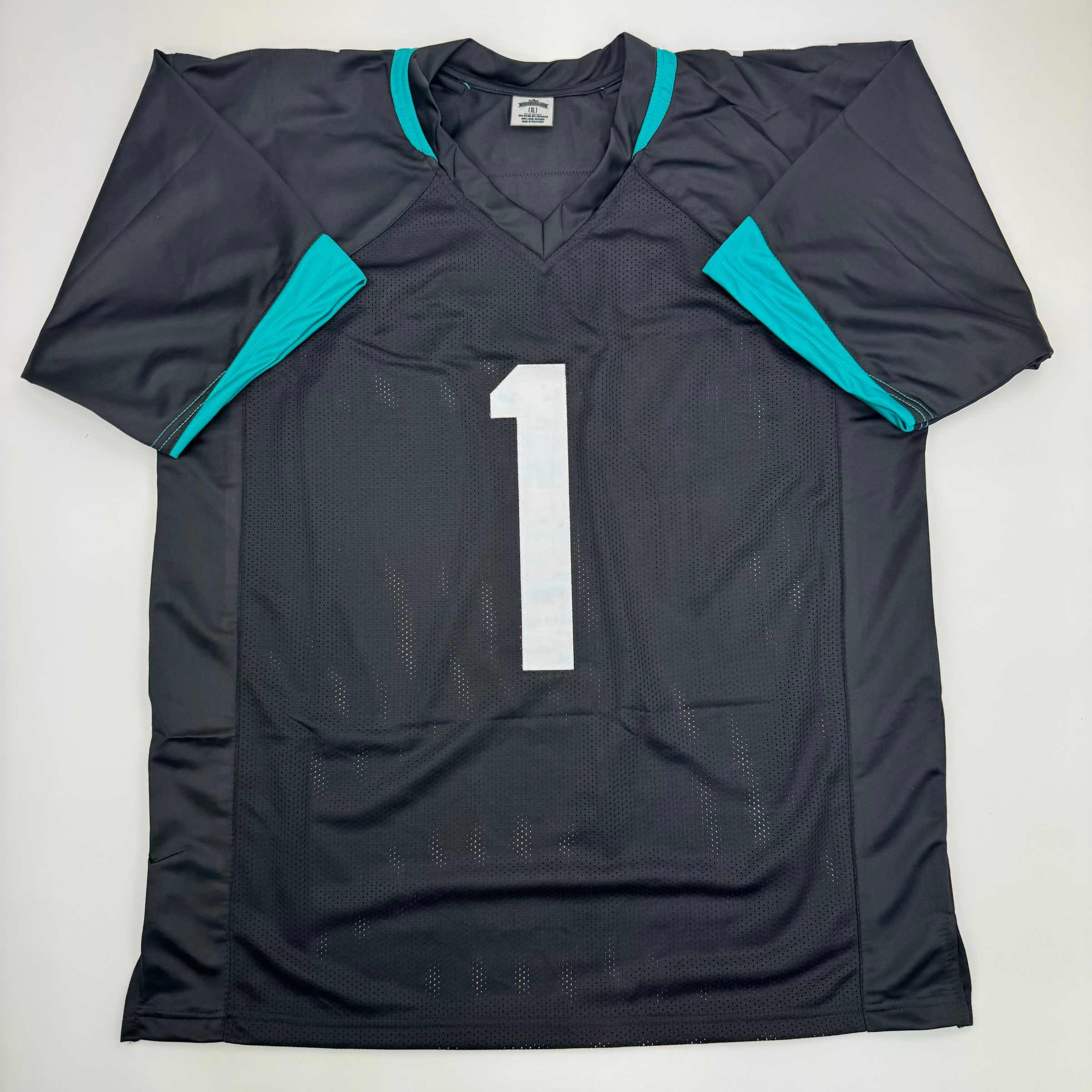 autographed-signed-travis-etienne-jr-jacksonville-black-football-jersey-beckett-bas-coa