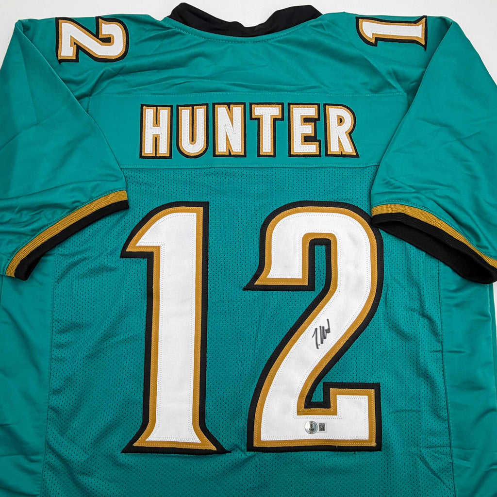 autographed-signed-travis-hunter-jacksonville-teal-retro-football-jersey-beckett-bas-coa