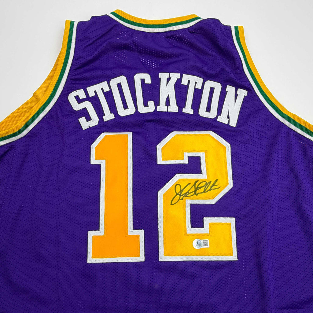 autographed-signed-john-stockton-utah-purple-basketball-jersey-beckett-bas-coa