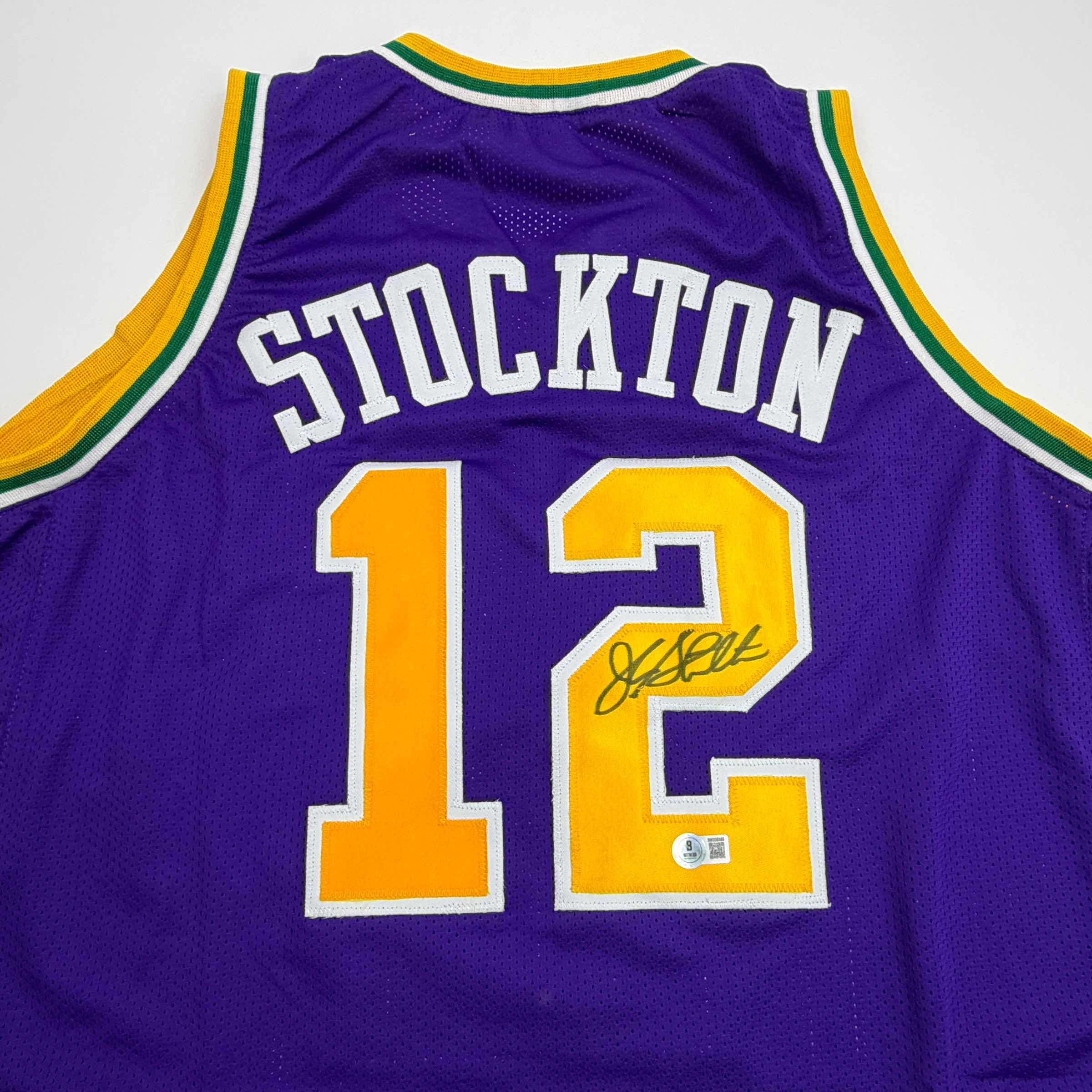 autographed-signed-john-stockton-utah-purple-basketball-jersey-beckett-bas-coa