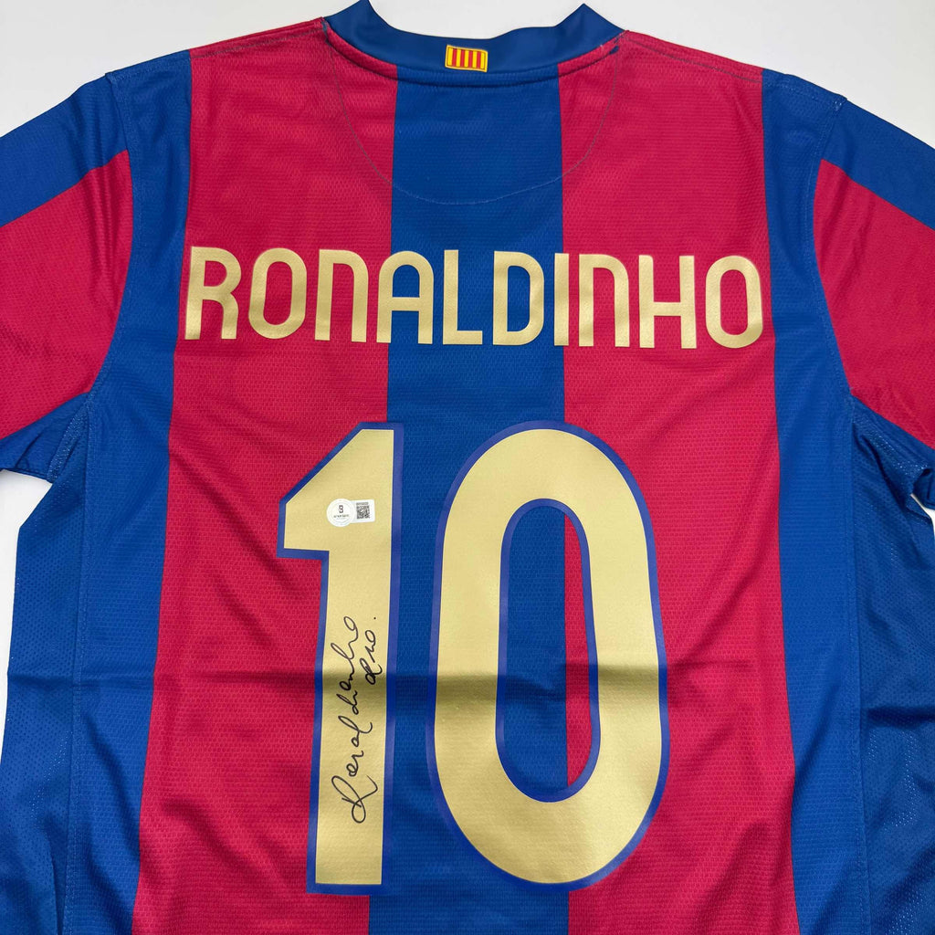 autographed-signed-ronaldinho-barcelona-blue-red-soccer-jersey-beckett-bas-coa-1