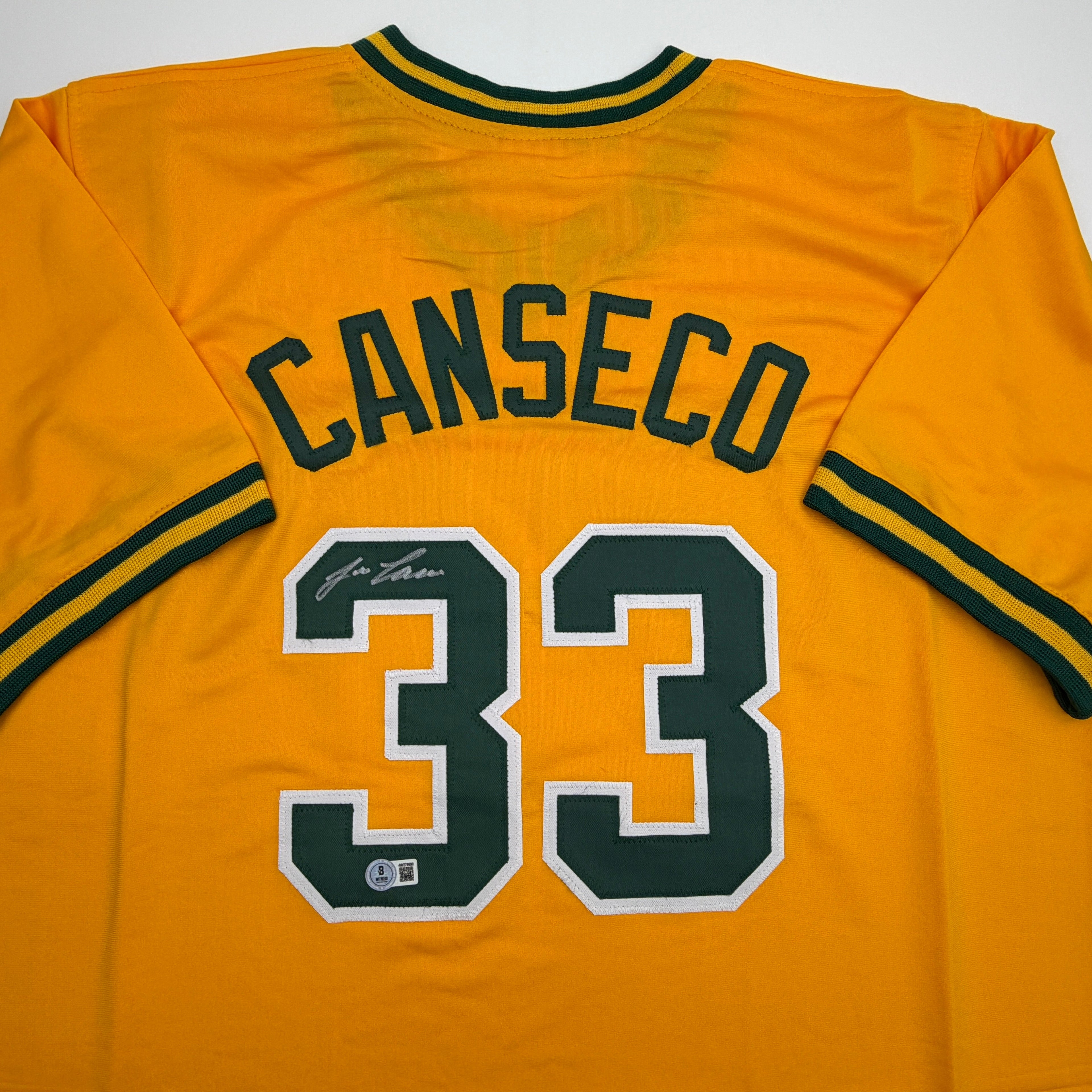autographed-signed-jose-canseco-oakland-yellow-baseball-jersey-beckett-bas-coa