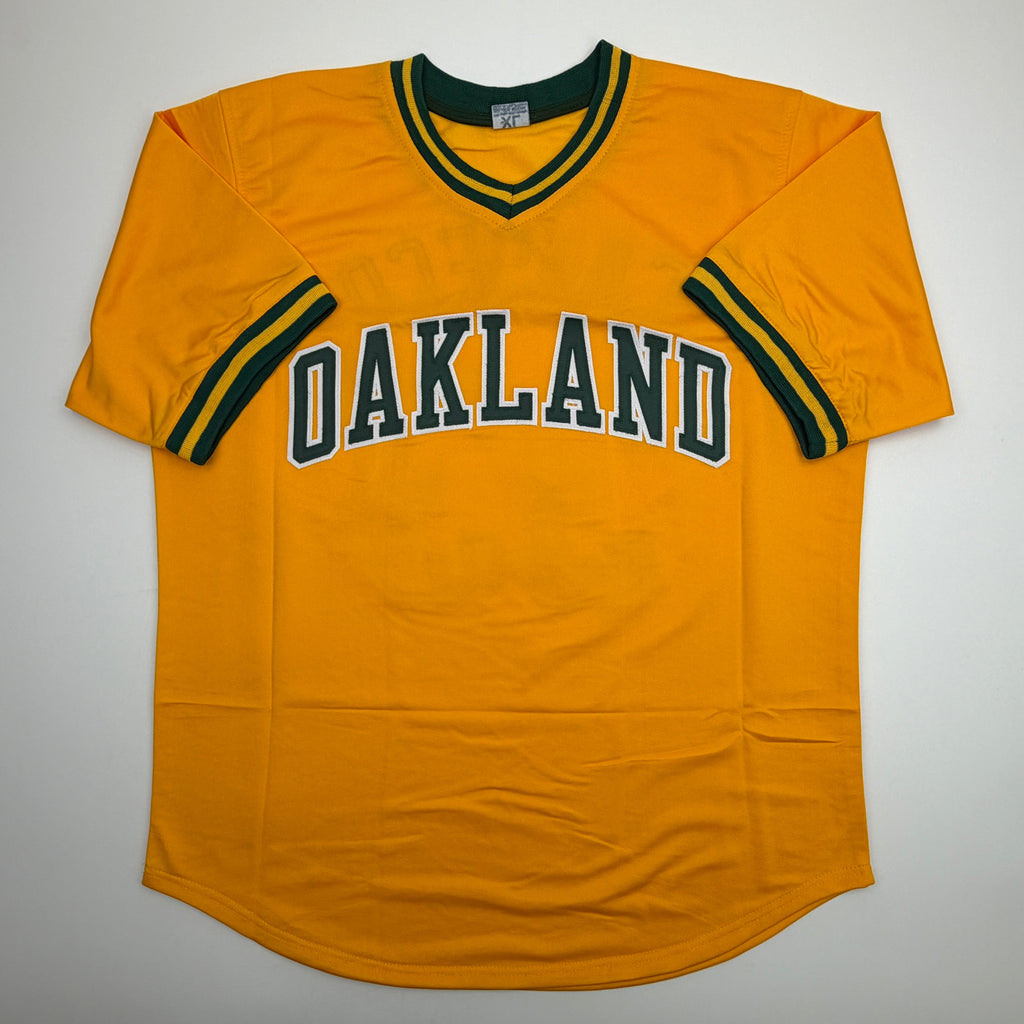autographed-signed-jose-canseco-oakland-yellow-baseball-jersey-beckett-bas-coa