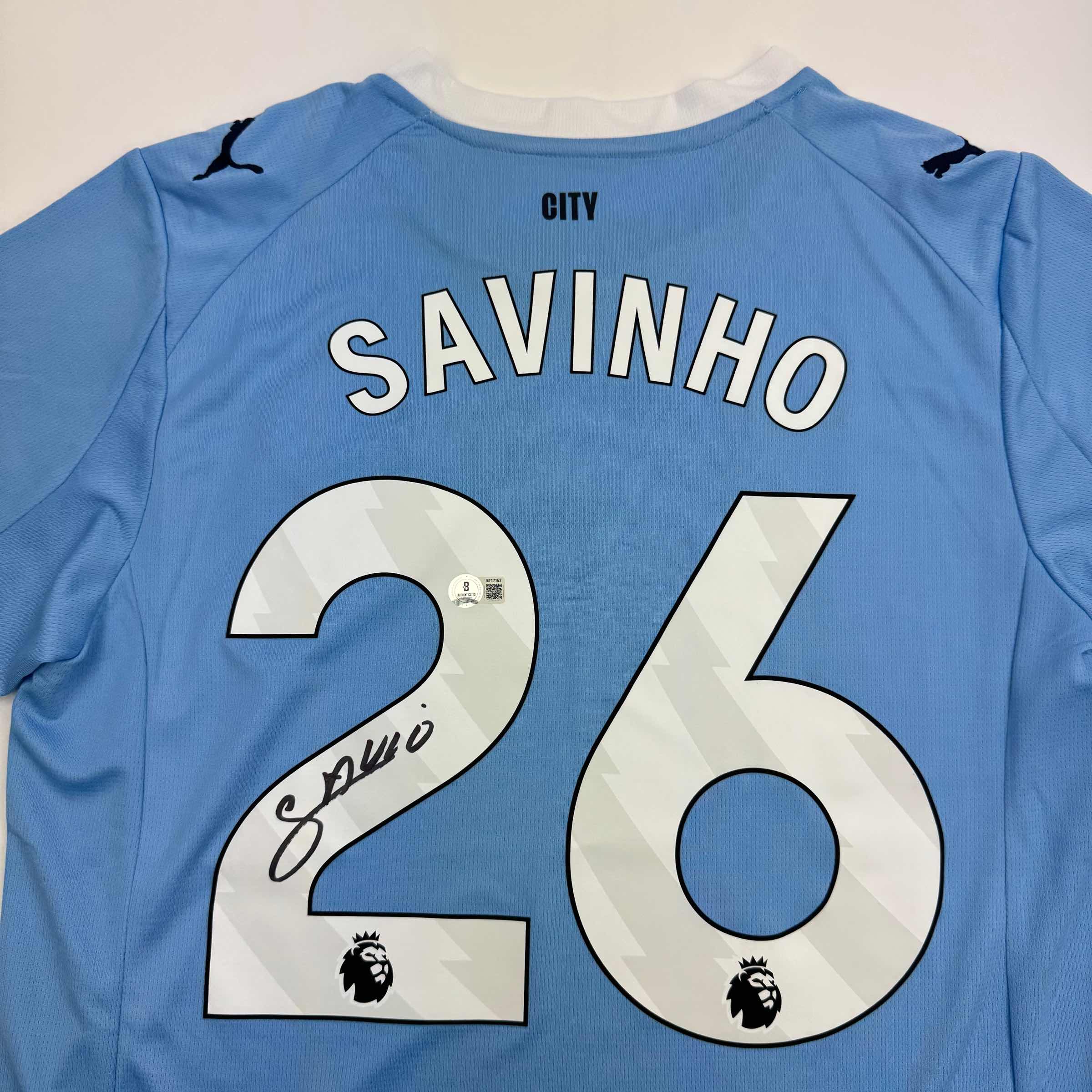 autographed-signed-savinho-manchester-city-blue-soccer-futbol-jersey-beckett-bas-coa